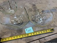 Overall view of square bowl with dip bowl and holder, round punch bowl with cups, tape for scale