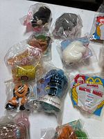 Group of sealed toys showing Ty Beanies, Toy Story item, Charlie Brown, Marvel pack