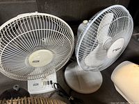 SMC white fan next to another white fan showing size and controls