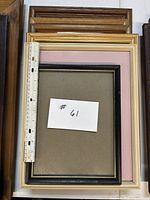 Stack of five frames with ruler for scale showing 8×10 opening and mixed finishes