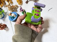 Green and purple vehicle accessory along with surrounding Lion King figures