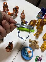 Group view of several Lion King figures, Rafiki platform, hyena, purple creature