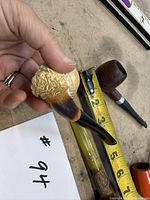 Three briar/meerschaum pipes with tape for scale