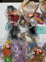 Group of sealed Teenie Beanie Babies with some paper Happy Meal wrappers visible