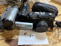 Group shot of all three cameras, battery and pouch