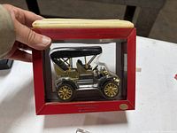 Boxed vintage touring car model with brass-tone finish