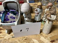 Group shot showing ceramic baby carriage with pincushion and four figurines