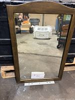 Front view of mirror showing entire wood frame and glass