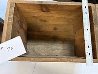 Top view inside first crate showing wood interior and scale