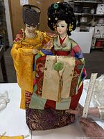 Front view of both dolls showing attire and size measurement