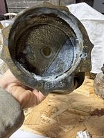 Underside of one lamp base displaying cast metal construction and numeric stamp 618