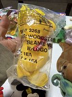 Sealed yellow Woodstock plush bag close-up