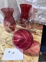 Six vases grouped on table showing colors and shapes