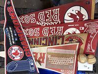 Stack of five pennants and two baseballs