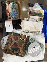 Full lot view showing napkins, handkerchiefs, ribbon spool