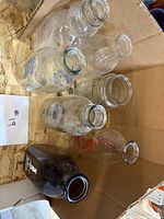 Top view showing six glass bottles/jar inside carton