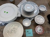 Assorted plates, bowls, cup and sugar bowl arranged on table