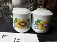 Pair of porcelain sunflower shakers front view