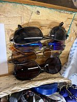 Four pairs sunglasses with two blue barrettes visible