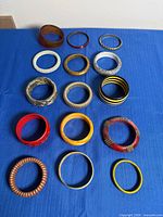 All 15 bangles laid out to show variety of materials, colours and sizes