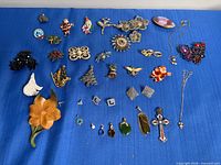 Overview of all costume jewelry pieces on blue fabric