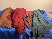 All fabric pieces spread out with pins container visible