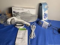 Rowenta Ultrasteam steamer with accessories and box alongside Whitmor fabric shaver