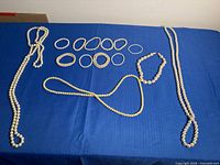 Lot overview showing three necklaces and ten bracelets