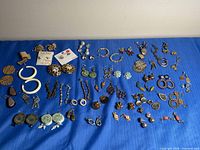 Full layout of all earring pairs on blue cloth