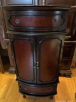 Front view of closed jewelry cabinet