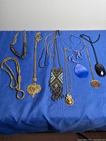 All eight necklaces laid out showing styles and pendants