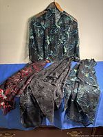 All four embroidered sheer ponchos displayed together