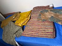 Overview of five folded fabric pieces on table