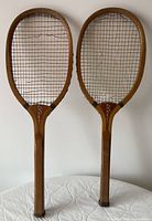 Both racquets front view showing Star logo and string condition