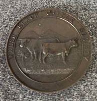 Front of bronze medal showing cattle image and society legend