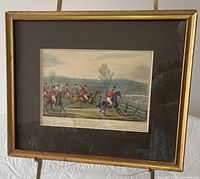 Framed aquatint on easel showing full view with mat and frame