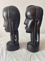 Side view of both ebony Maasai head busts showing profiles and bases