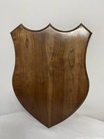 Front of walnut shield plaque showing finish and grain