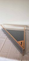 Overall view of triangular plexiglass case on table