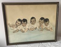 Front view of framed Dionne Quintuplets print showing tinted image and frame