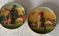 Front view of both plates showing relief towers and painted village scenes
