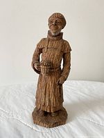 front view of hand-carved wood friar holding beer mug