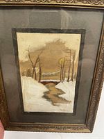 Front view close-up of framed artwork showing scene, frame detail