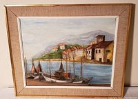Front view of framed oil painting showing harbour scene