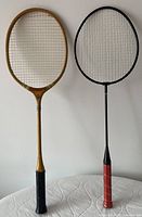 Front view of both badminton rackets standing side by side