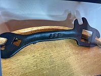 Overall view of cast iron JFS tractor wrench showing both ends and embossed initials