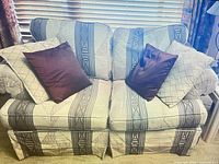 Front view of patterned loveseat with four pillows