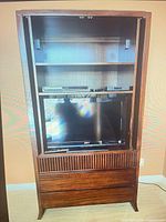 Cabinet front open showing interior shelves and drawers