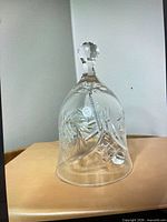 full view of clear cut crystal dinner bell showing starburst pattern and faceted knob handle