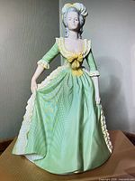 Front view of figurine showing costume details and posture